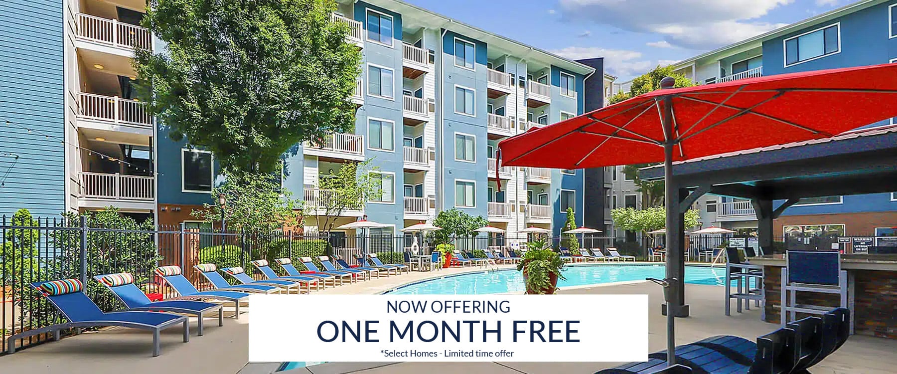 Apex West Midtown apartment complex pool area with lounge chairs and umbrellas; banner in foreground reads "Now Offering One Month Free.