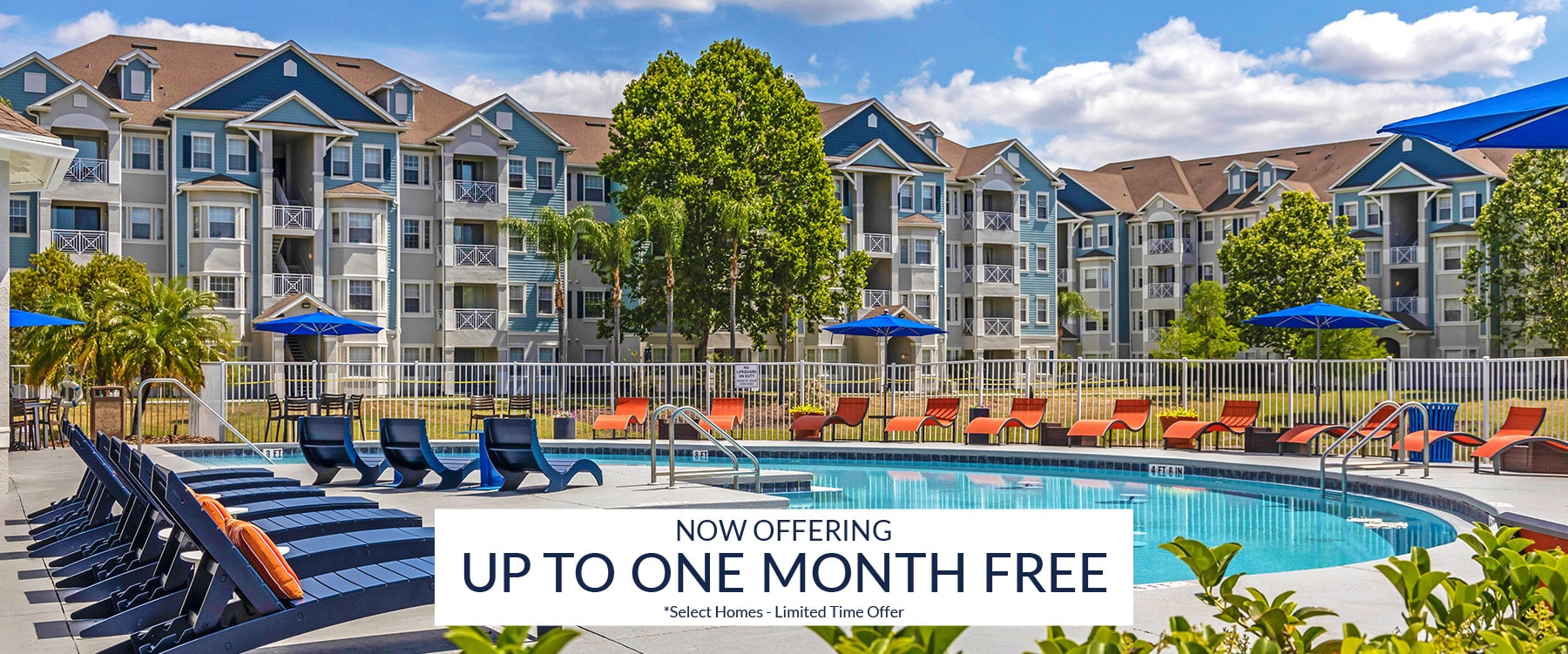 Relax by the outdoor pool at Cane Island, featuring lounge chairs, umbrellas, and a fenced area in front of multi-story apartment buildings. Banner reads "Now Offering Up to One Month Free.