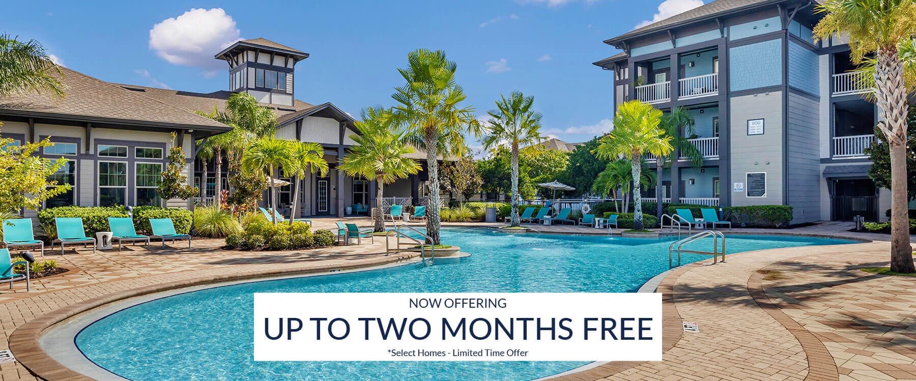 Relax by the outdoor swimming pool area at Gateway North, an inviting apartment complex featuring palm trees, lounge chairs, and a sign reading “Up to Two Months Free” as a limited time offer.