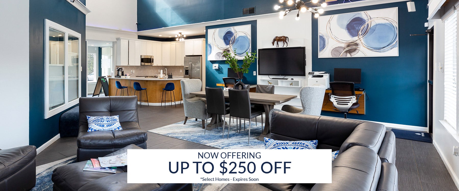 Modern living room and kitchen area with blue and white decor, contemporary furniture, and a promotional banner offering up to $250 off select Steeplechase homes.