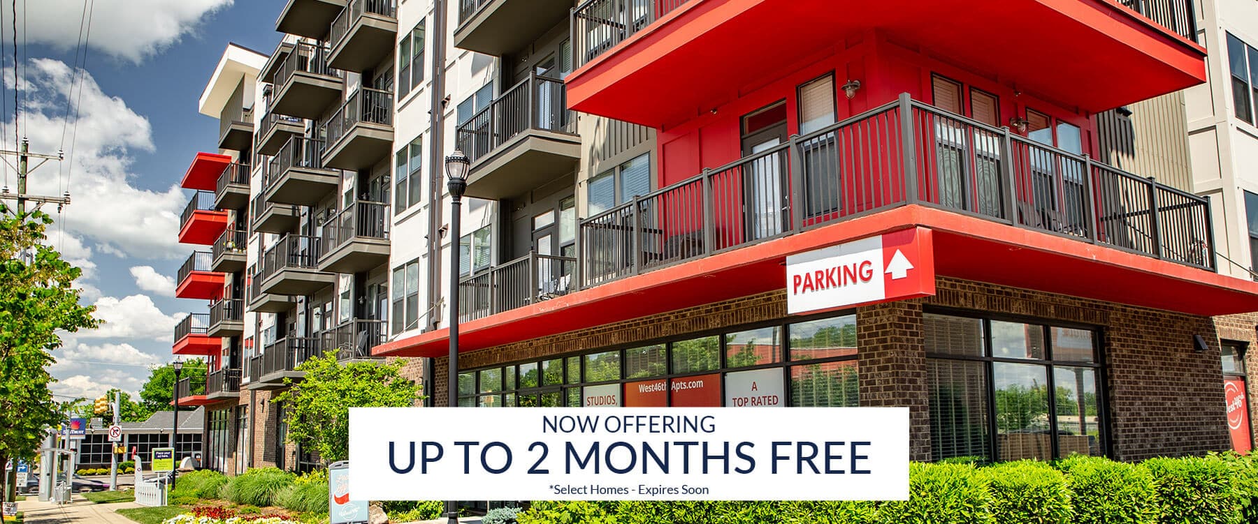 Modern Sylvan Park apartment building in Nashville with balconies and a sign advertising "Now offering up to 2 months free" rent for select apartments for rent.